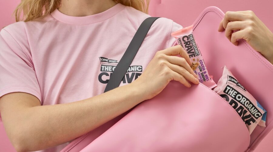 a woman in a pink shirt holding a pink bag